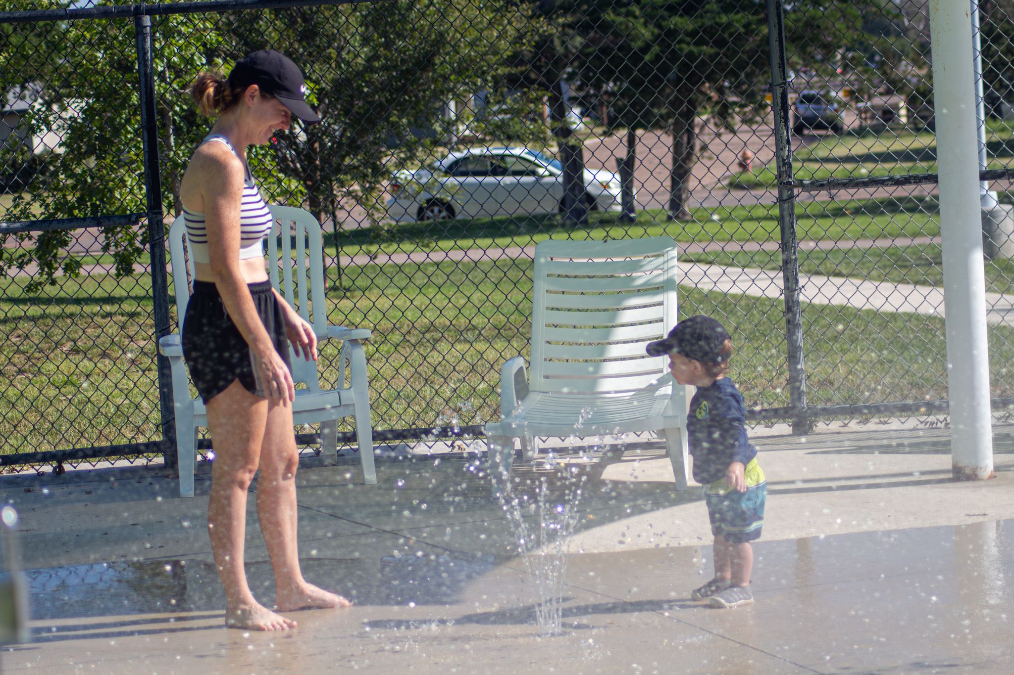 Mother and son playing around with a water feature in our splash pad